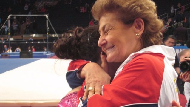 Martha Karolyi hugs Aly Raisman after the 2012 American Cup