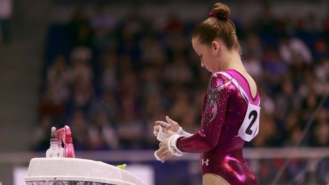 Madison Kocian chalks up for bars