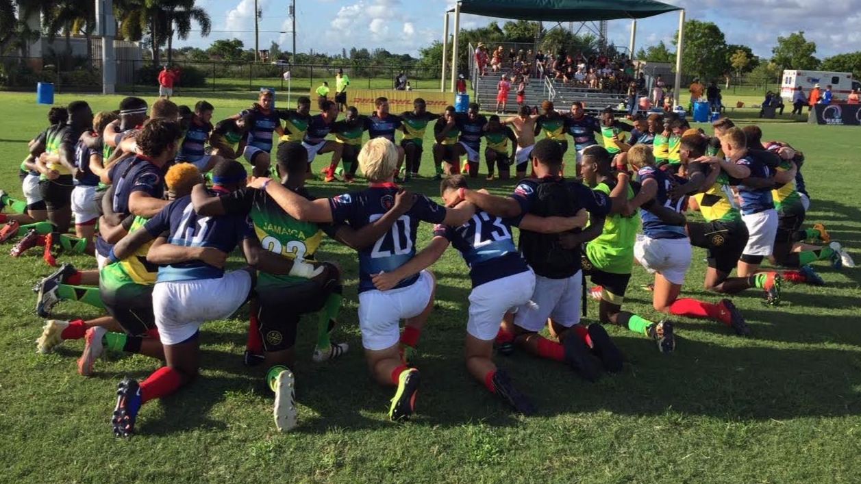 USA and Jamaica players huddle up after a physical opening round game that produced several injuries.